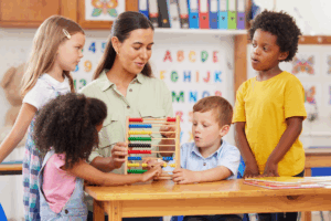 A child engaging in play-based ABA therapy with a therapist using naturalistic teaching strategies