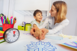 ABA therapist using shaping technique with child during therapy session